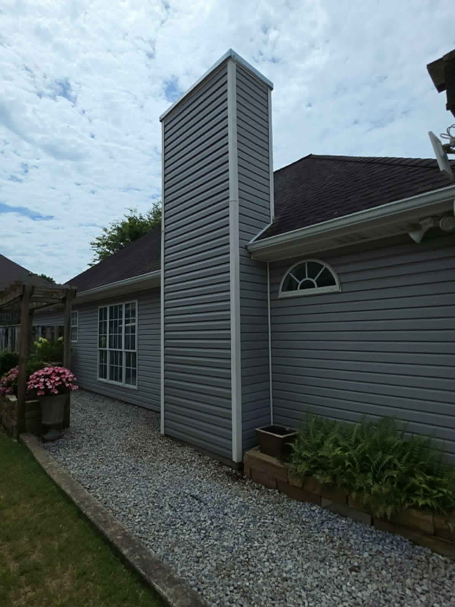 Repaired exterior siding with replaced rotted wood on a home facade.